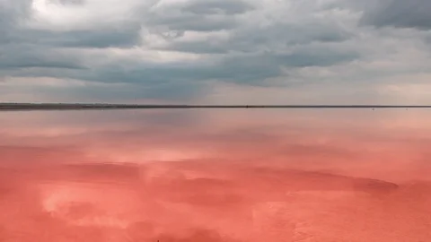 Clouds reflected in the smooth water of the pink lake. Stock Footage 120358795