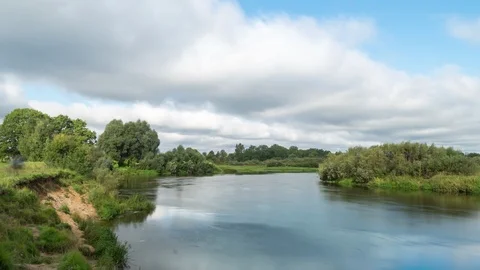 Clouds reflected in the smooth water of a river. Stock Footage 115206125