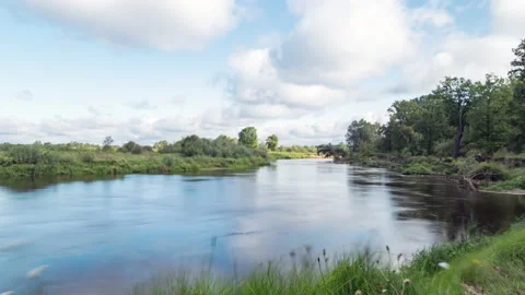 Clouds reflected in the smooth water of a river. Stock Footage 169063561