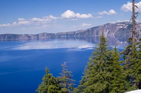 Clouds reflected in a view of crater lake Stock Photos