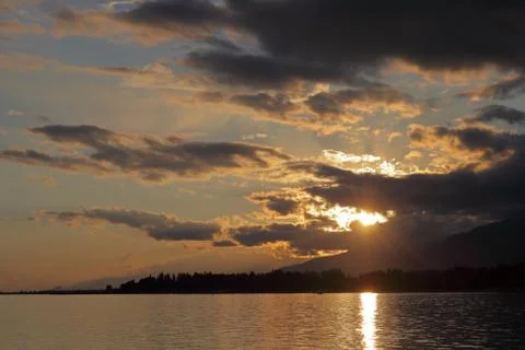 Clouds reflected on the water during sunset Stock Photos