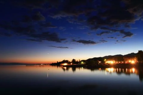 Clouds reflected on the water during sunset Stock Photos