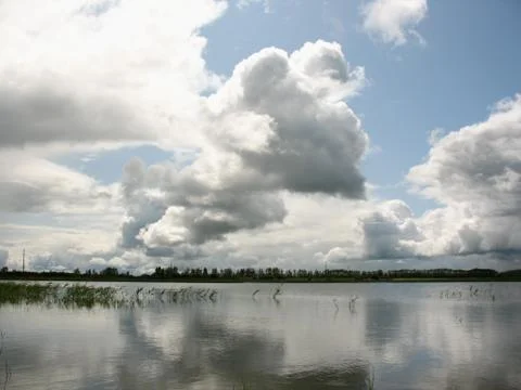Clouds reflected in the water of the lake Stock Photos