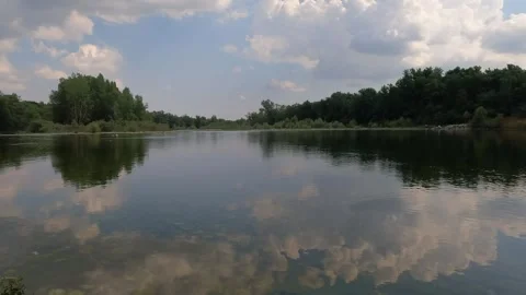 Clouds reflected in the water of the Ticino river Stock Footage 311829585