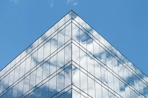 Clouds reflected in the windows of a modern building Stock Photos
