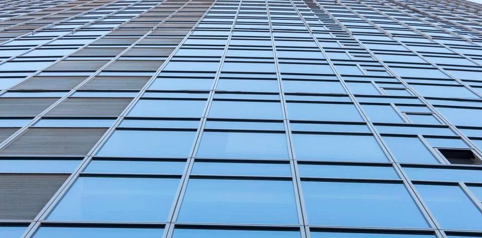 Clouds Reflected in Windows of Modern Office Building Stock Photos