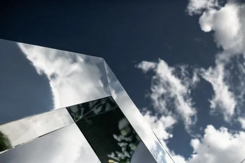 Clouds reflected in windows of modern office building Fotos Stock