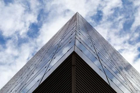 Clouds reflected in windows of modern office building. Stock Photos