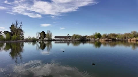 Clouds Reflecting on Dark Blue Water Stockbeeldmateriaal 270364857