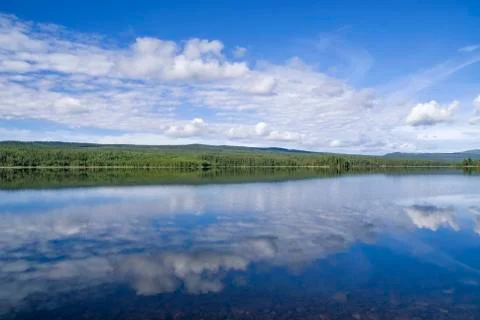 Clouds reflecting in lake Funasdalssjon Stock Photos