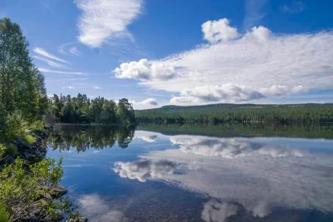 Clouds reflecting in lake Funasdalssjon Stock Photos