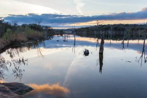 Clouds Reflecting on Large Lake During Sunset Stock Photos