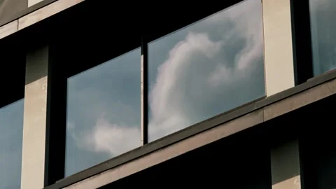 Clouds reflecting on a modern building window Stock Footage 334785159