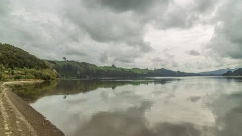 Clouds reflecting in the slow flowing Waikato River,4k,timelapse Stock Footage 229758482
