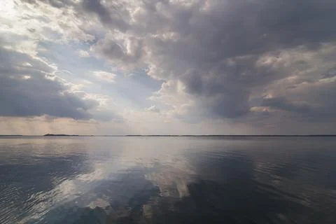 Clouds reflecting on water surface landscape photo Stock Photos