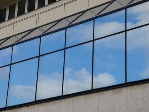 Clouds reflecting in windows Stock Photos