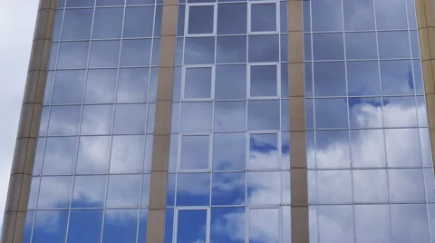 Clouds reflection on a glass facade - modern office Building - time lapse Stock Footage 63970621