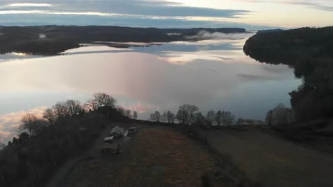 Clouds Reflection on Lake Surrounded by Forest, Aerial Backward Stock Footage 145485714