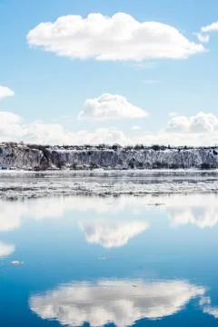 A clouds reflection in the river with floating ice Stock Photos