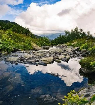 Clouds reflection on water surface 스톡 사진