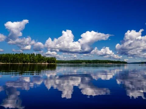 Clouds reflections on a Swedish lake Stock Photos