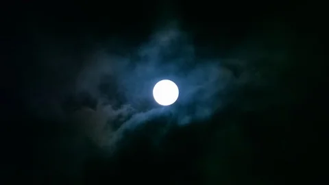Clouds revealing a full moon Stock Footage 124530817