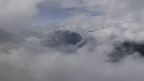 Clouds rising over rocky mountain peaks - Static Swiss Alps landscape Stock Footage 328405514