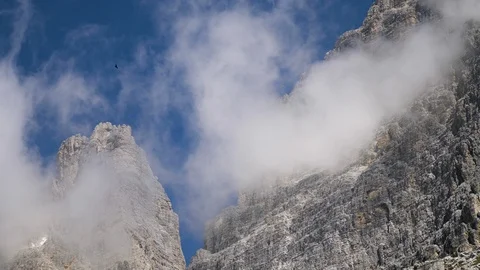 Clouds rising from peaks of Tre Cime di Lavaredo mountain region in Italy. 動画素材 112668432