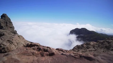 Clouds in the rock on a clear sunny day. Timelapse video. Waves of clouds in a Stock Footage 117171142