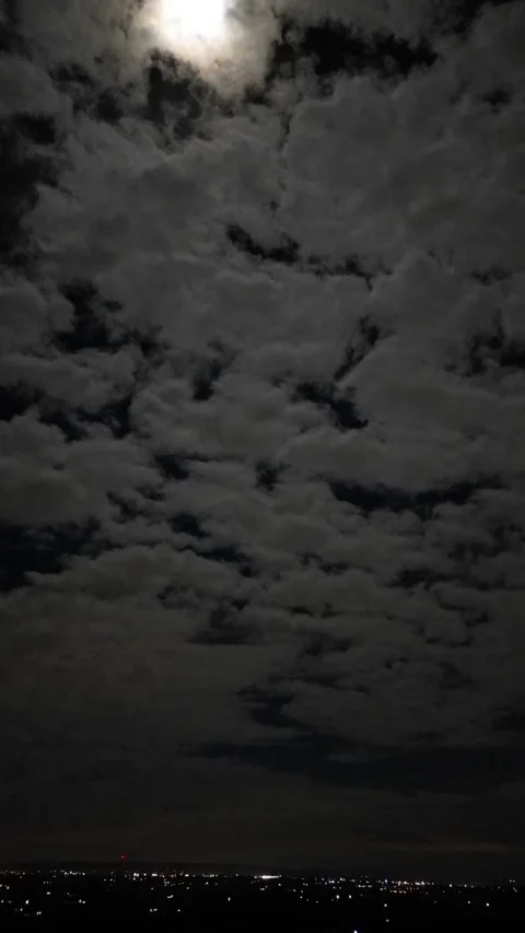Clouds roiling past full moon hyperlapse video Stock Footage 260352153