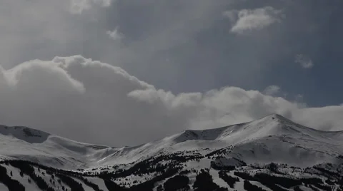 Clouds roll in casting shadow on a ski resort Stock Footage 58173004
