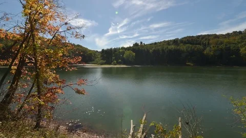Clouds roll by a lake in this Autumn time lapse Stock Footage 71145260
