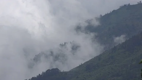 Clouds roll in on mountains around Wonosobo in central Java, Indonesia Stock Footage 78417109