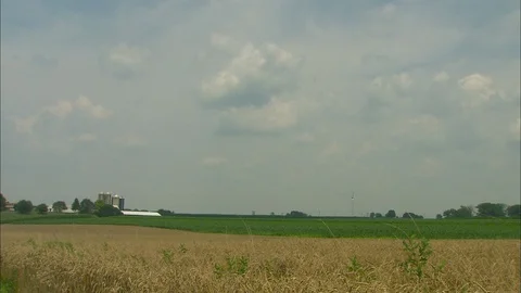 Clouds roll over distant farm 스톡 동영상 88024831