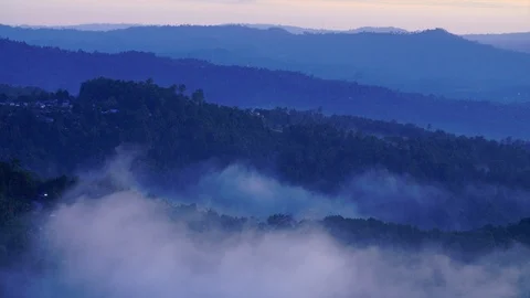 Clouds roll over the misty hills and towns of Munduk Bali Stock Footage 124997273