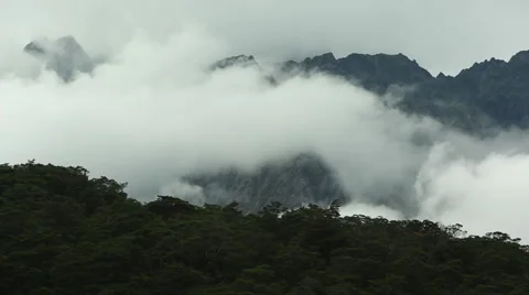 Clouds rolling across mountain peaks Stock Footage 55530096