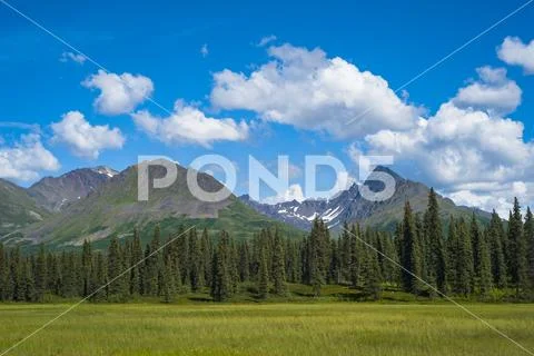 Clouds rolling across mountain peaks in the Talkeetna Range in South-central Ala Stock Photos