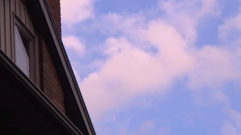 Clouds Rolling by the Exterior of a House HD Video Stock Footage 89811431