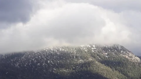 Clouds rolling over a beautiful mountain peak above Lake Tahoe 動画素材 130769715