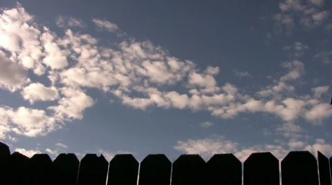 Clouds Rolling Over Fence Time Lapse 動画素材 555644