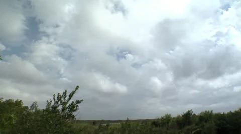 Clouds rolling over field Stock Footage 12761470