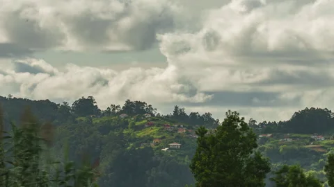 Clouds rolling over green hills and village houses in Madeira timelapse Видео 347213121