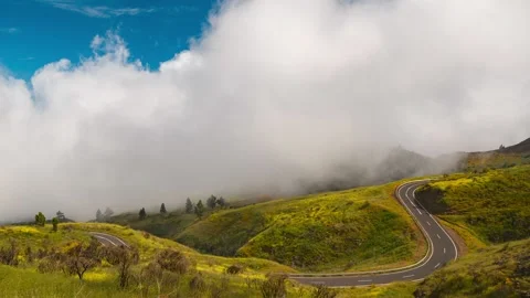 Clouds Rolling Over Green Meadow and Winding Road Tenerife 4K Timelapse Stock Footage 334398455
