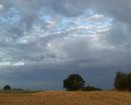 Clouds rolling over harvested field Stock Footage 65222
