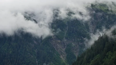 Clouds rolling over lush Alaskan mountains Stock Footage 65399828