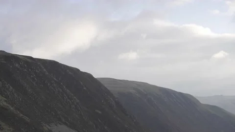 CLOUDS ROLLING OVER MOUNTAIN Stock-Footage 144385745