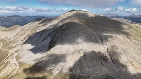 Clouds rolling over mountain pass summit with road visible below, Pindus range, Stock Footage 341871853