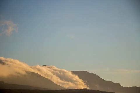 Clouds rolling over mountain Stock Photos