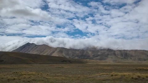 Clouds rolling over mountain range,4k,timelapse Stock Footage 229801238