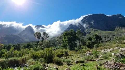 Clouds Rolling In Over Mountain On A Sunny Day. Stock Footage 166945156